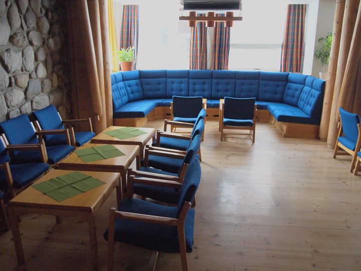 a room with a couch and chairs