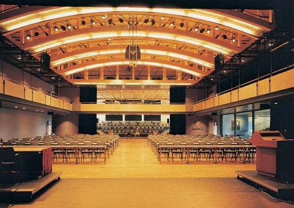 a large auditorium with chairs and a stage