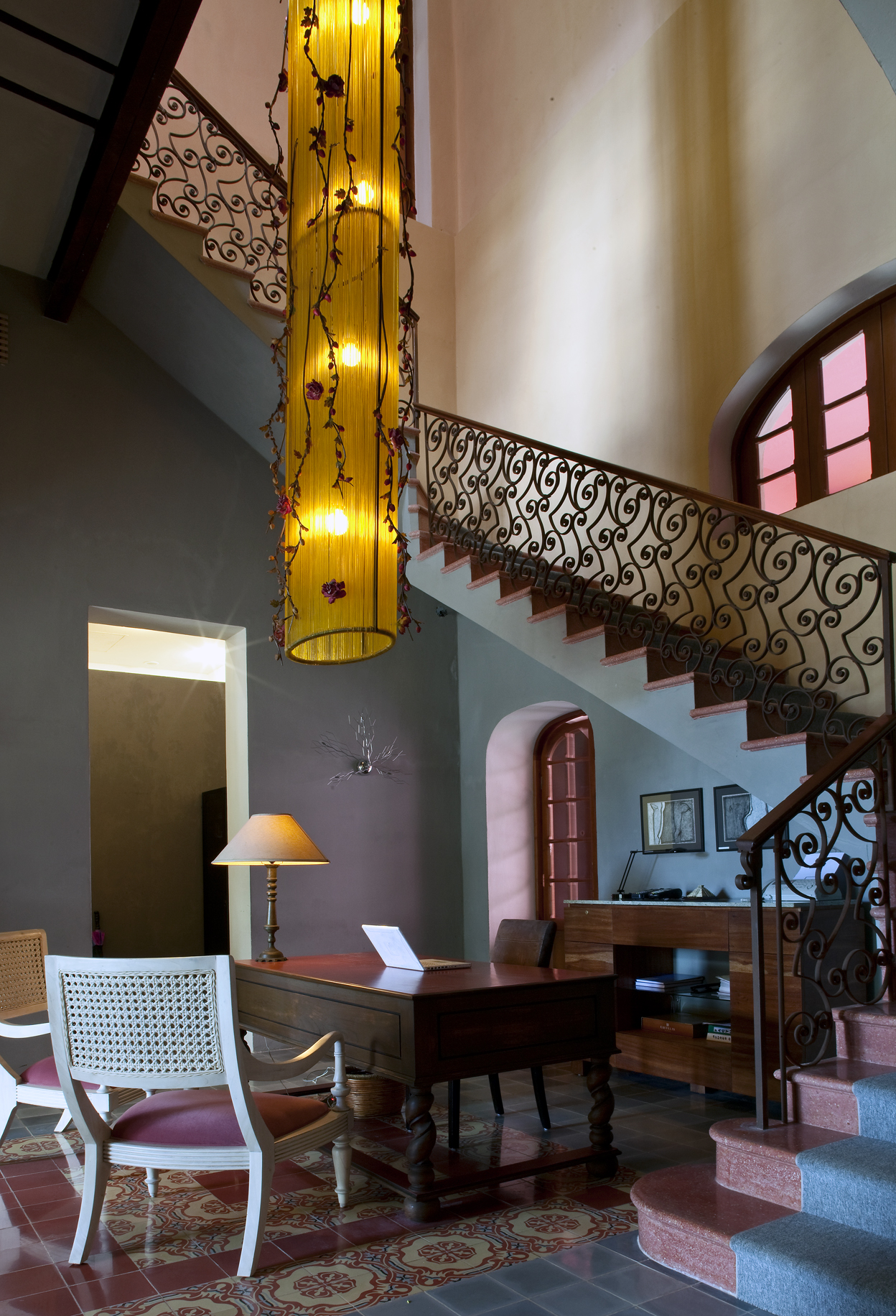 a room with a staircase and a desk