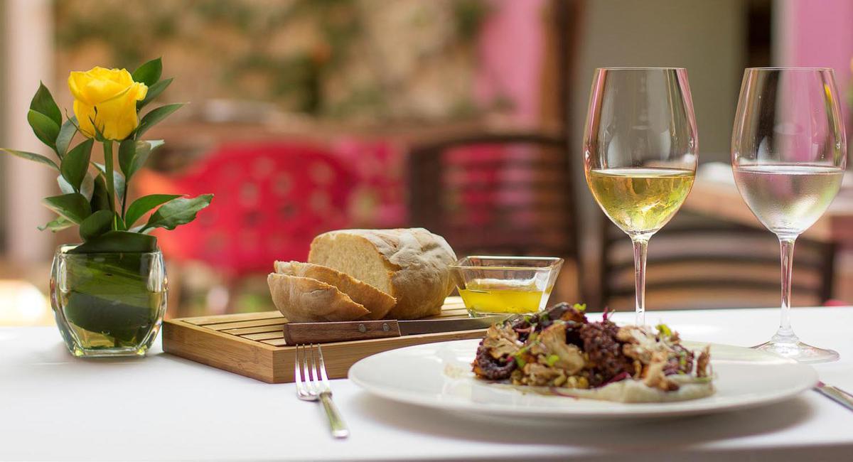 a plate of food and a glass of wine
