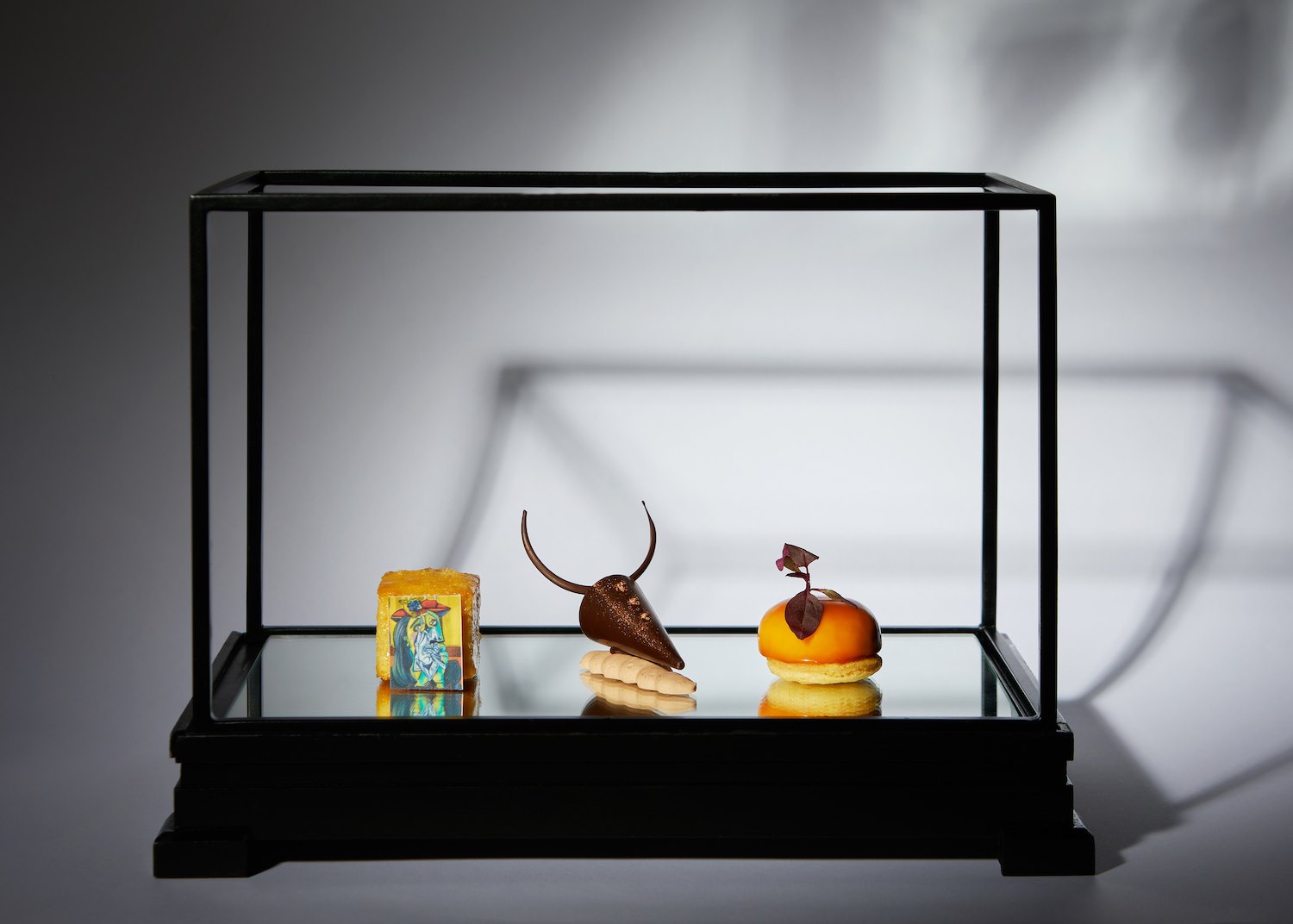 a glass case with food on it