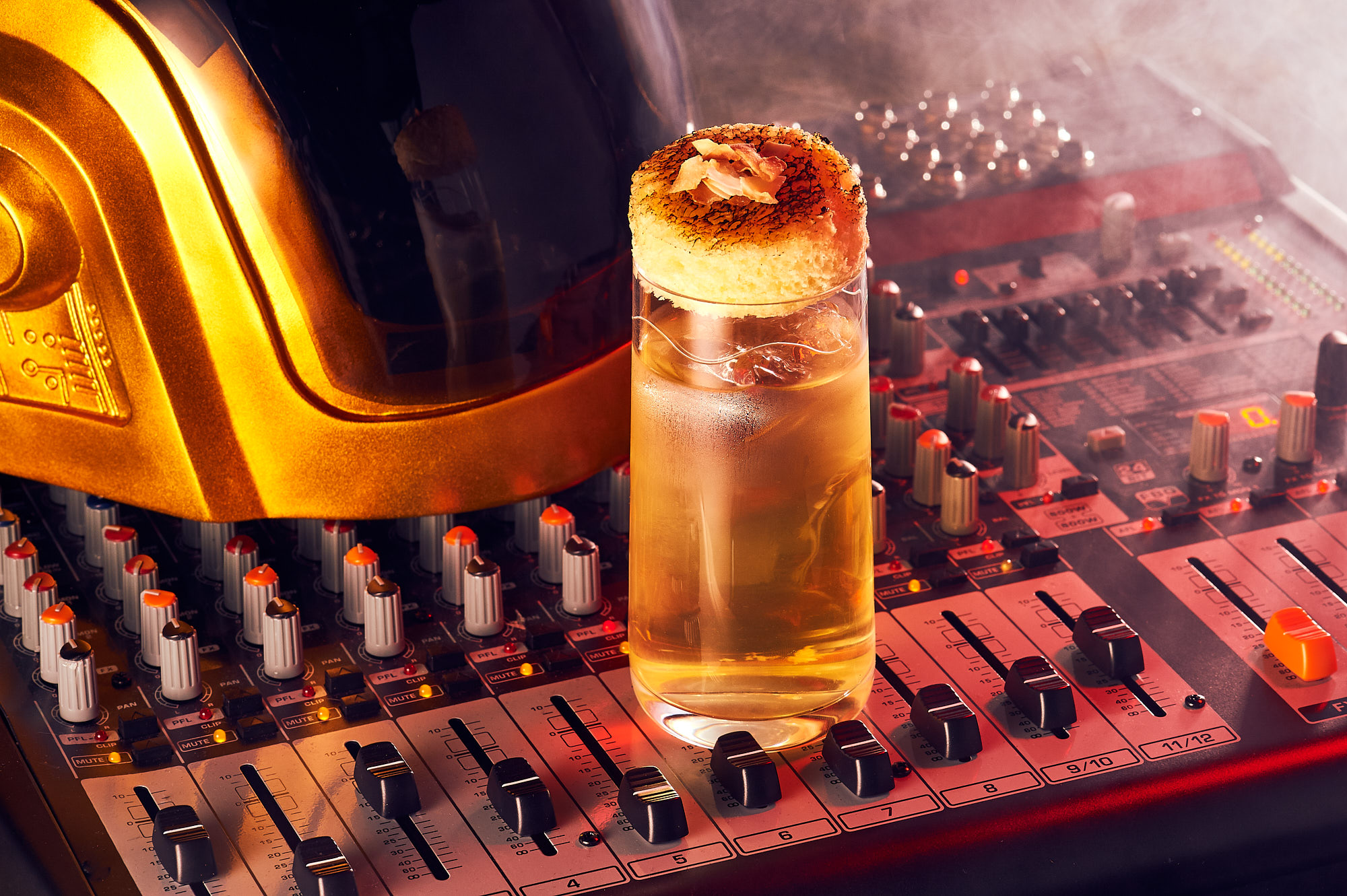 a glass of liquid on a sound board