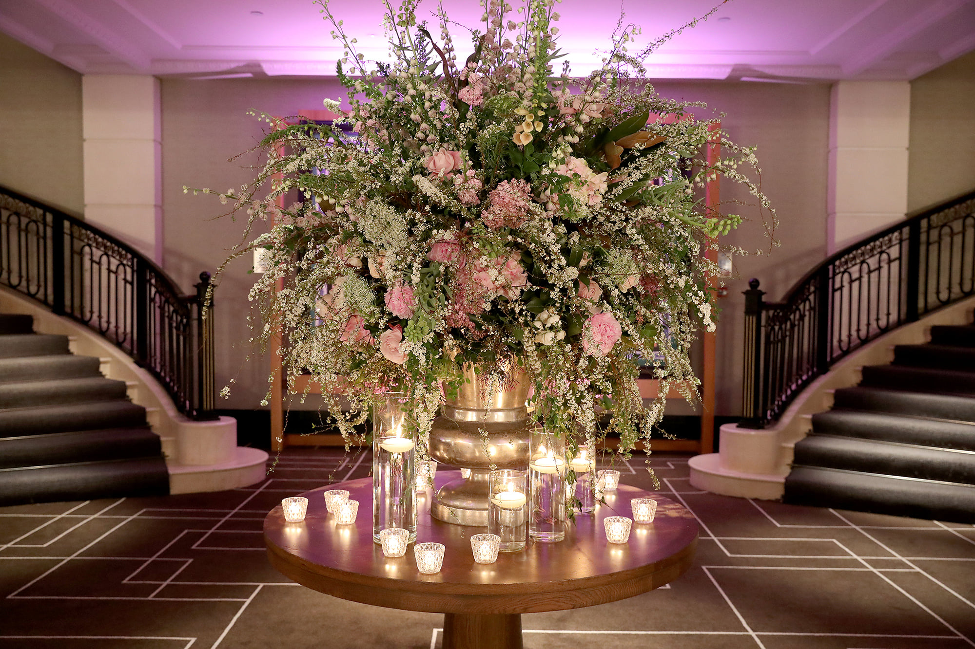 a large bouquet of flowers on a table with candles
