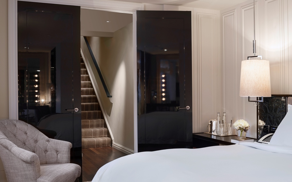 a bedroom with a black door and stairs