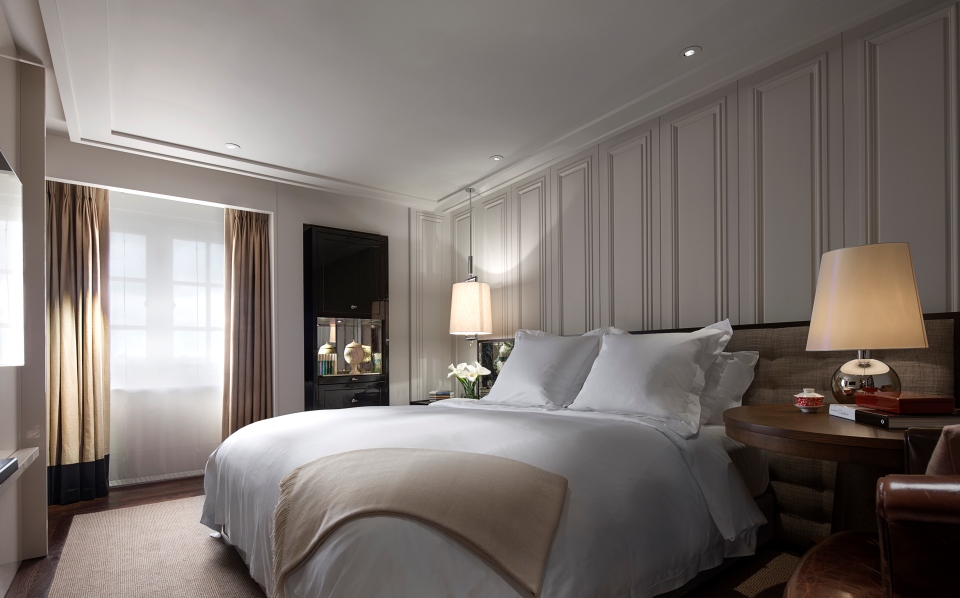 a bed with pillows and a lamp in a room