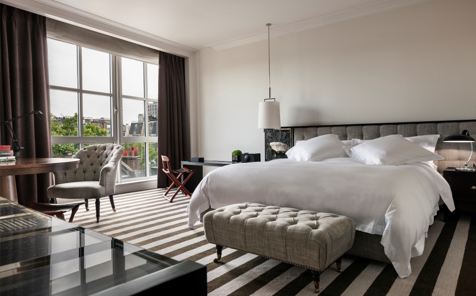 a bedroom with a bed and a chair