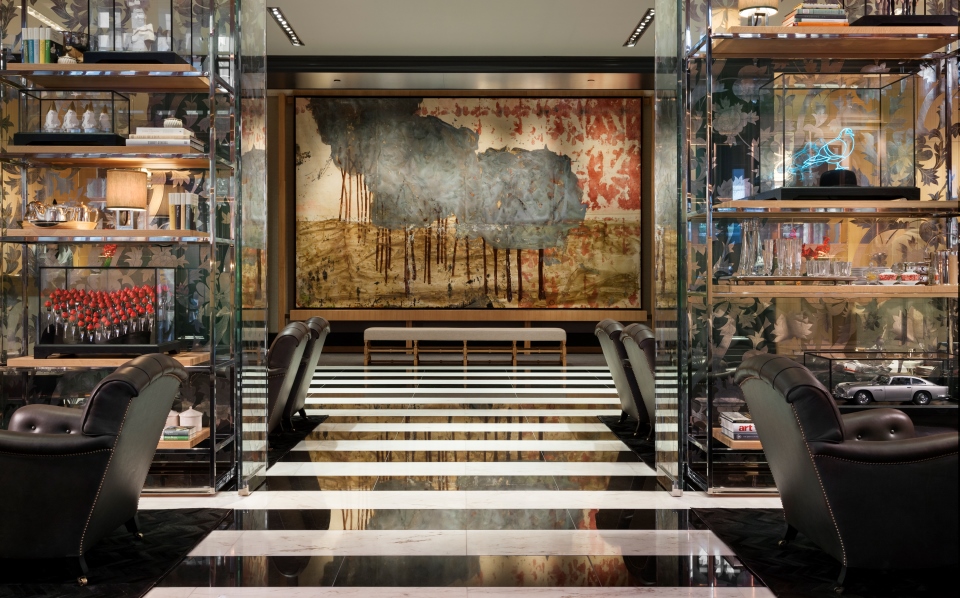a room with chairs and a painting on the wall
