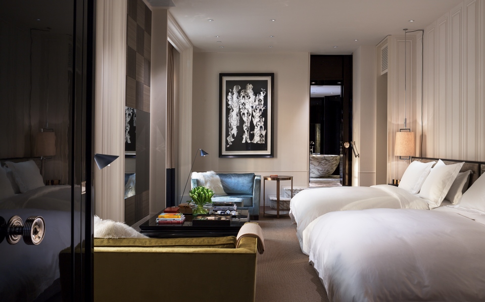 a room with two beds and a table
