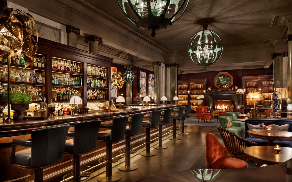 a bar with a fireplace and chairs