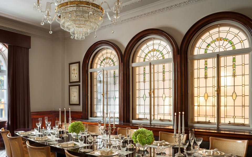 a dining room with a chandelier and glass windows