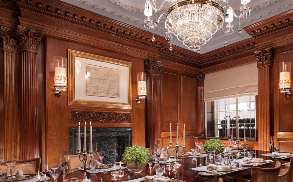 a dining room with a chandelier and candles