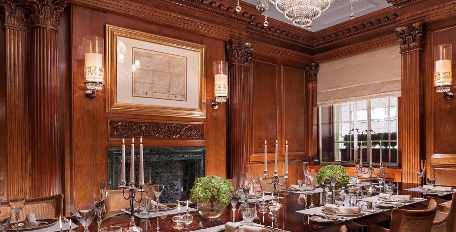 a dining room with a fireplace and chandeliers
