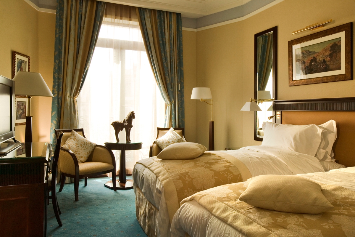 a hotel room with two beds and a table