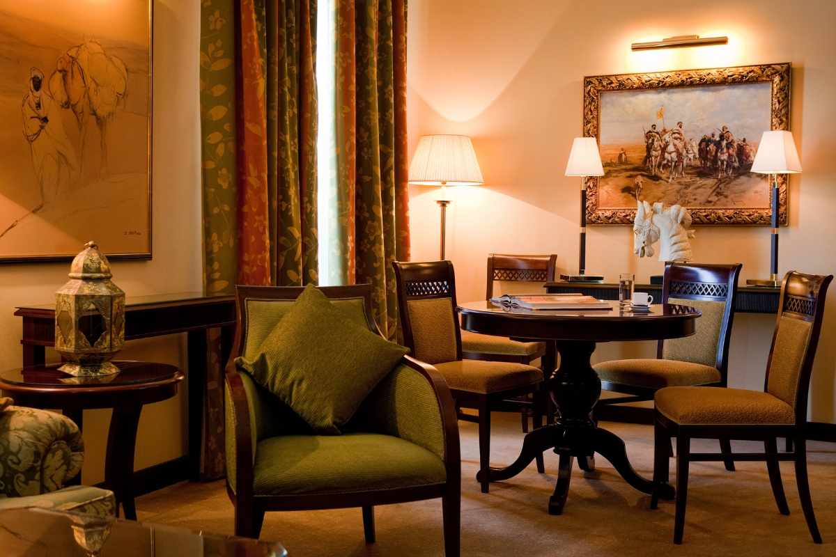 a room with a round table and chairs