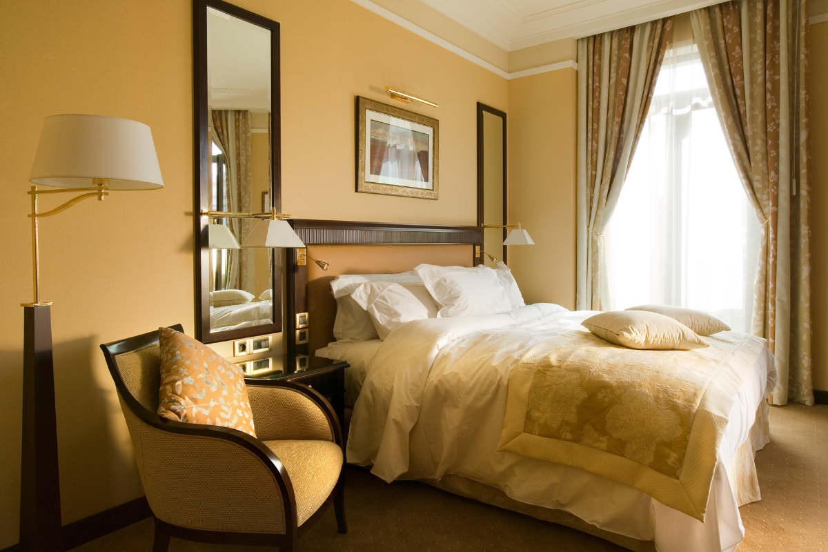 a bedroom with a bed and a chair