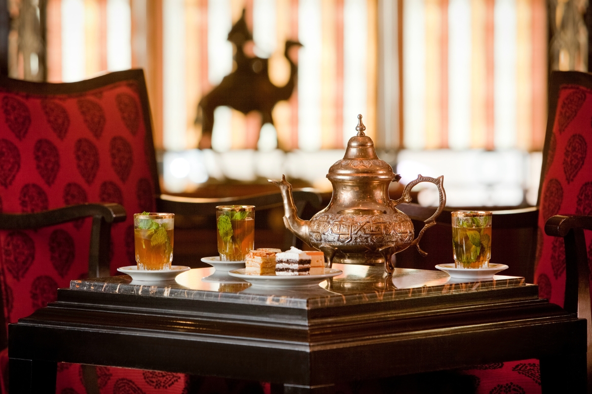 a table with teapot and cups of tea on it