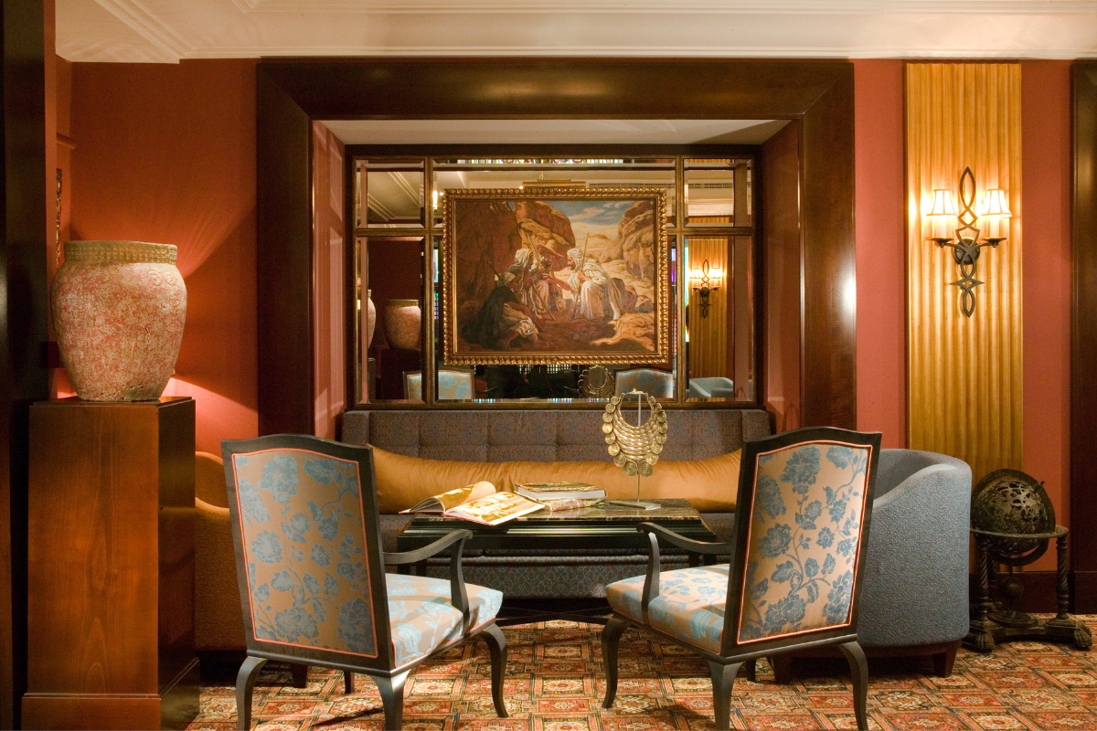 a room with a couch and chairs