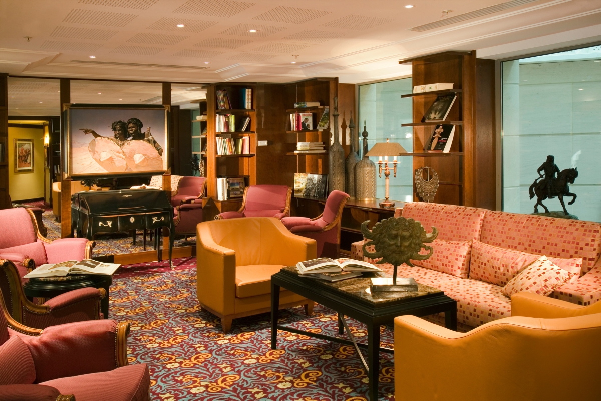 a room with a piano and couches