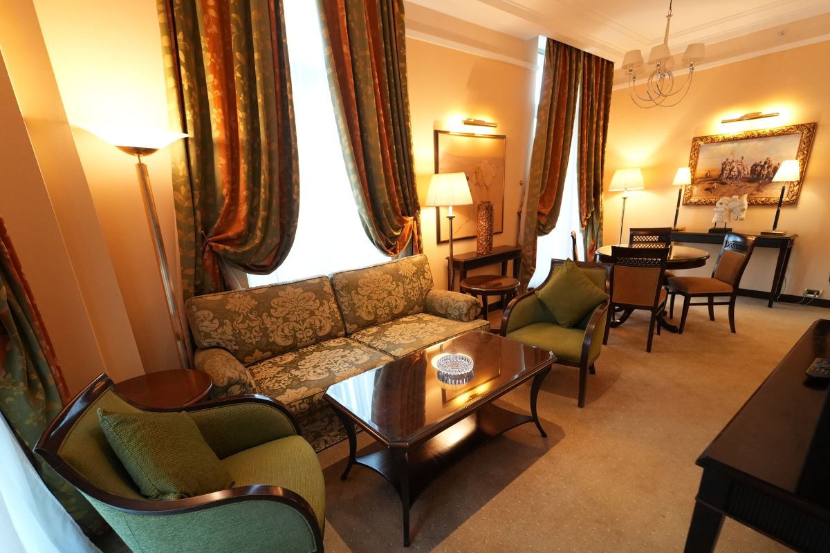 a room with a couch and chairs