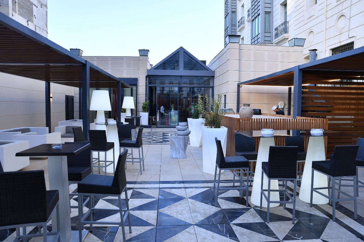 a patio with chairs and tables