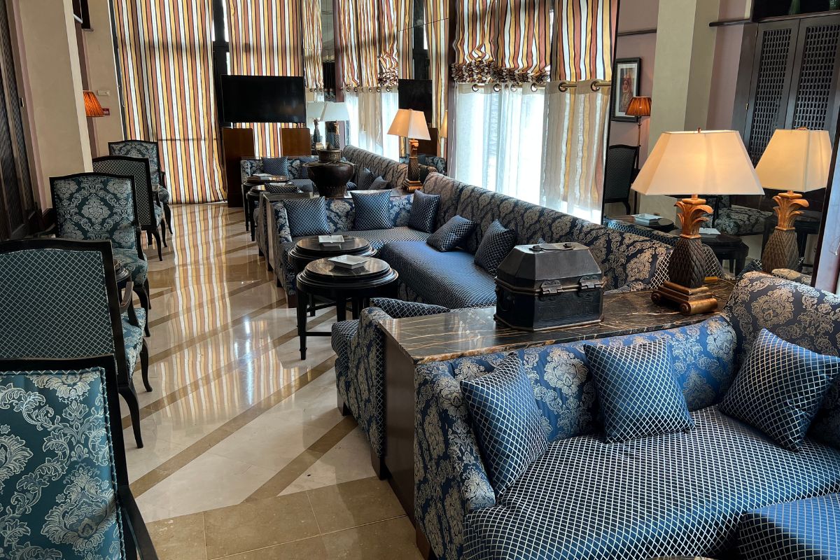 a room with a couch and chairs