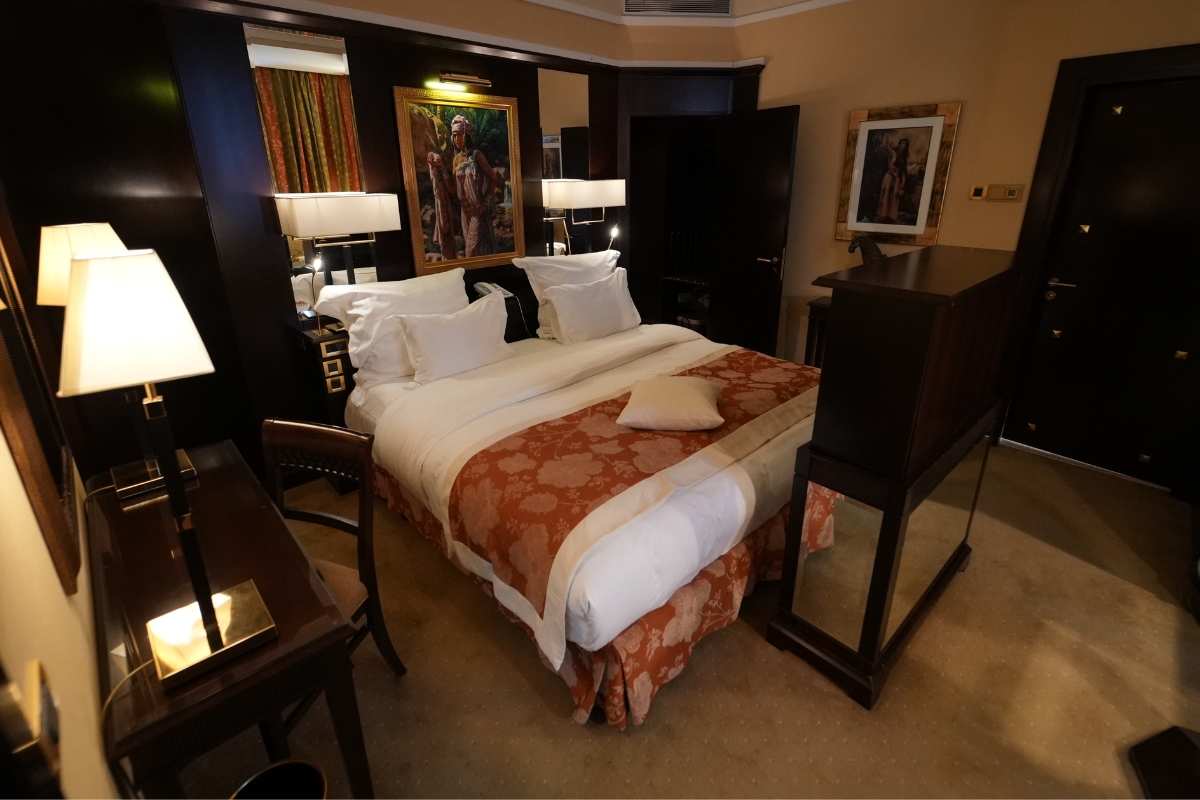 a bed with a mirror and lamps