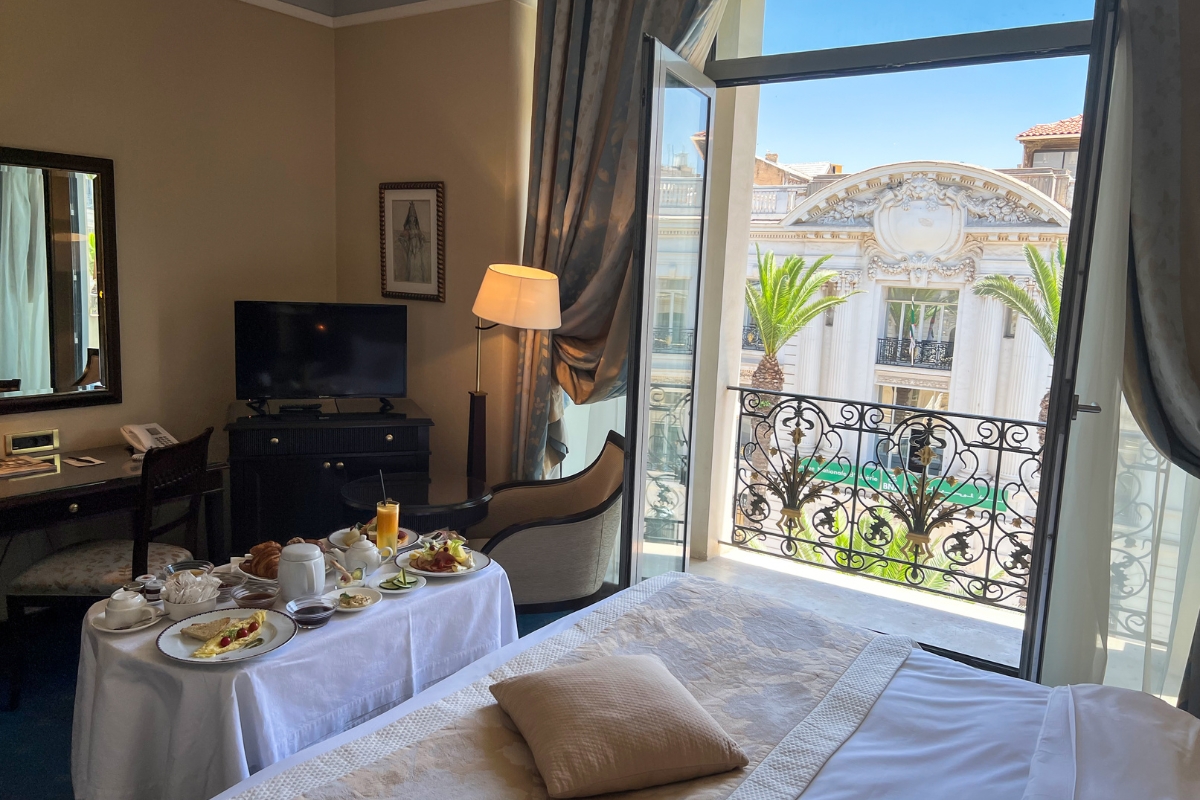 a room with a bed and a table with food on it
