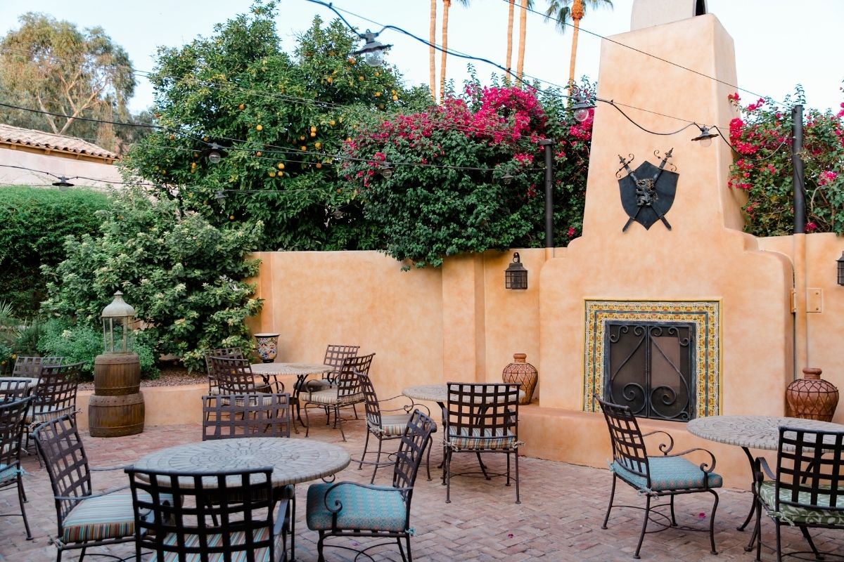a patio with chairs and tables