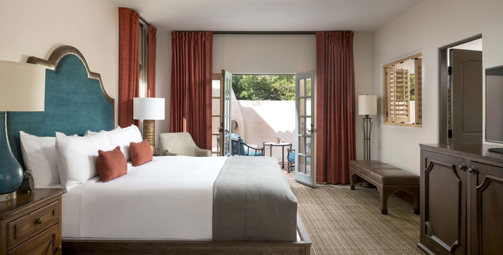 a room with a bed and a bench