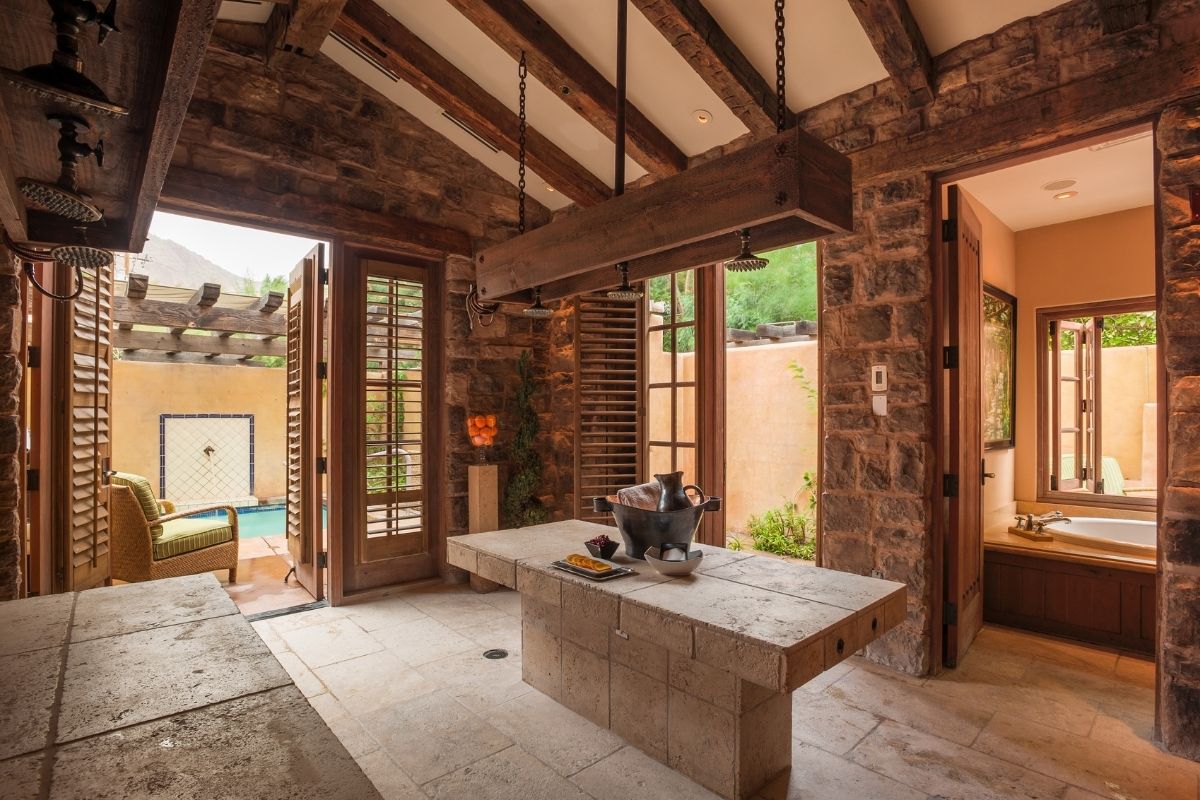 a stone table in a room with a stone wall and a stone ceiling