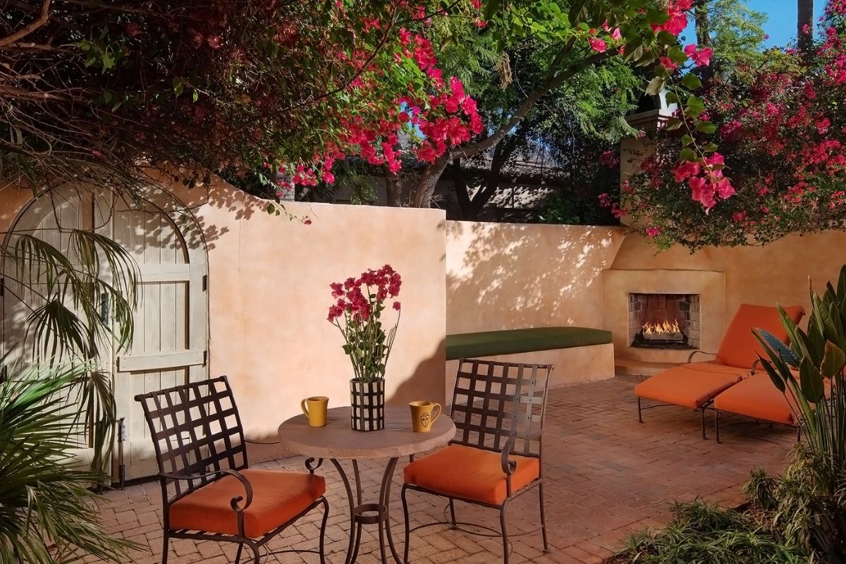 a patio with chairs and a table