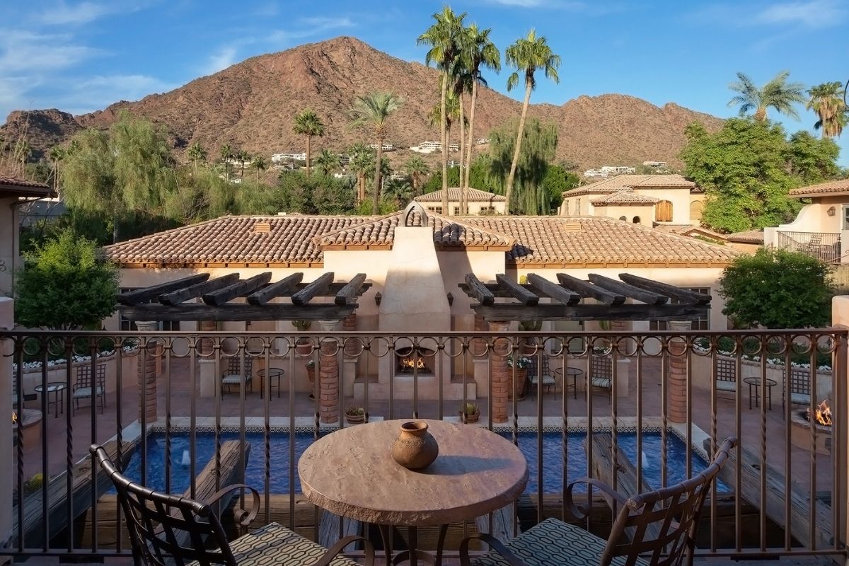 a patio with a pool and a table