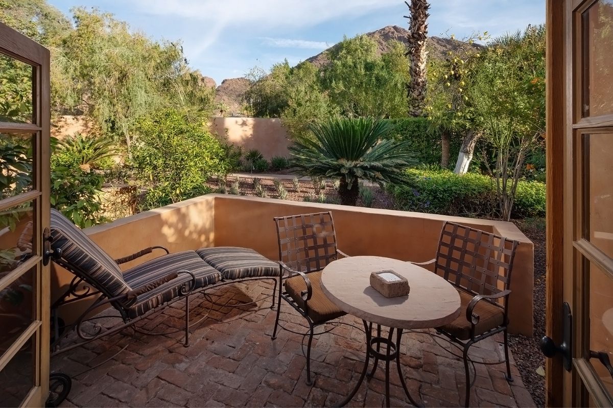 a patio with chairs and a table