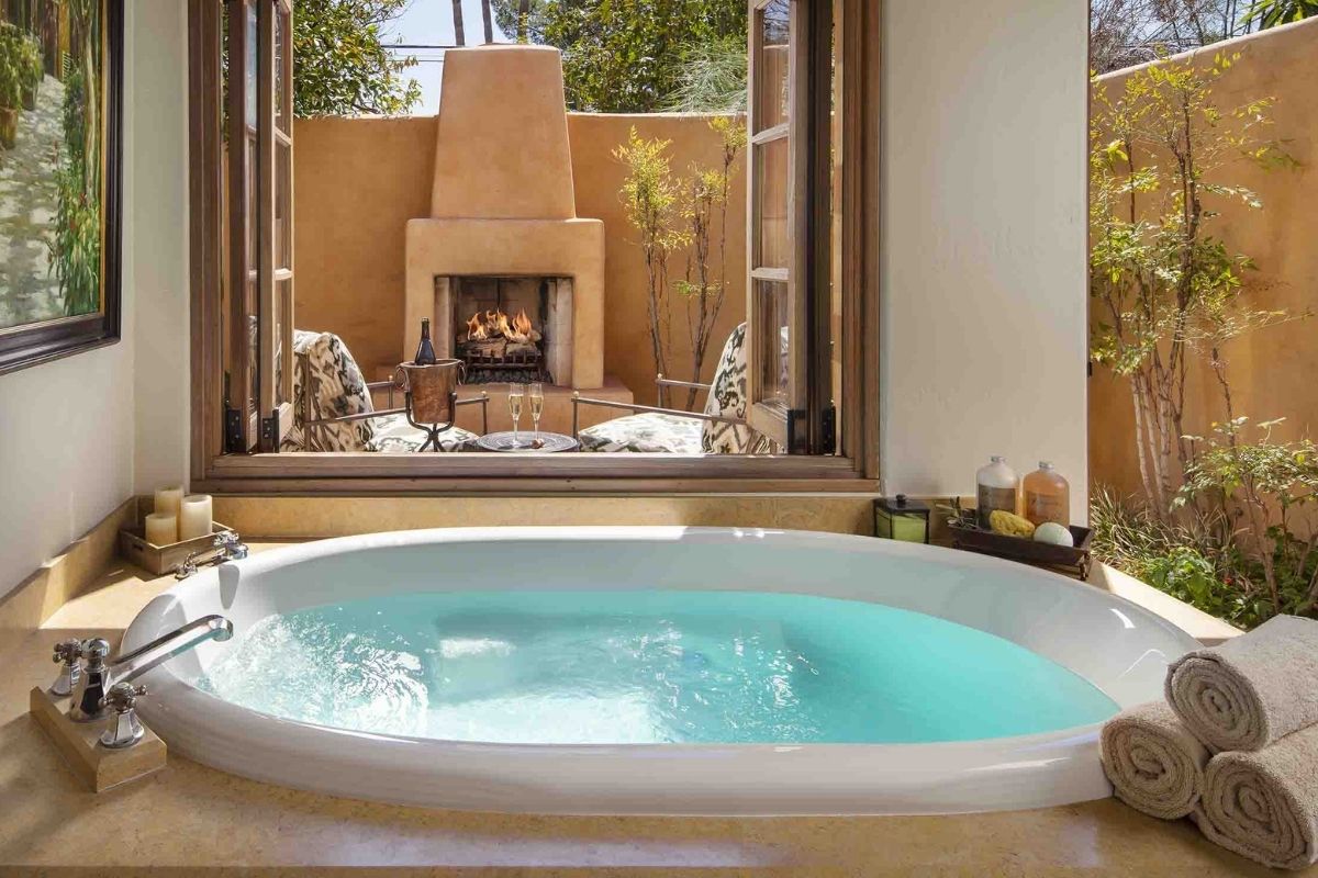 a tub with a fireplace in the background