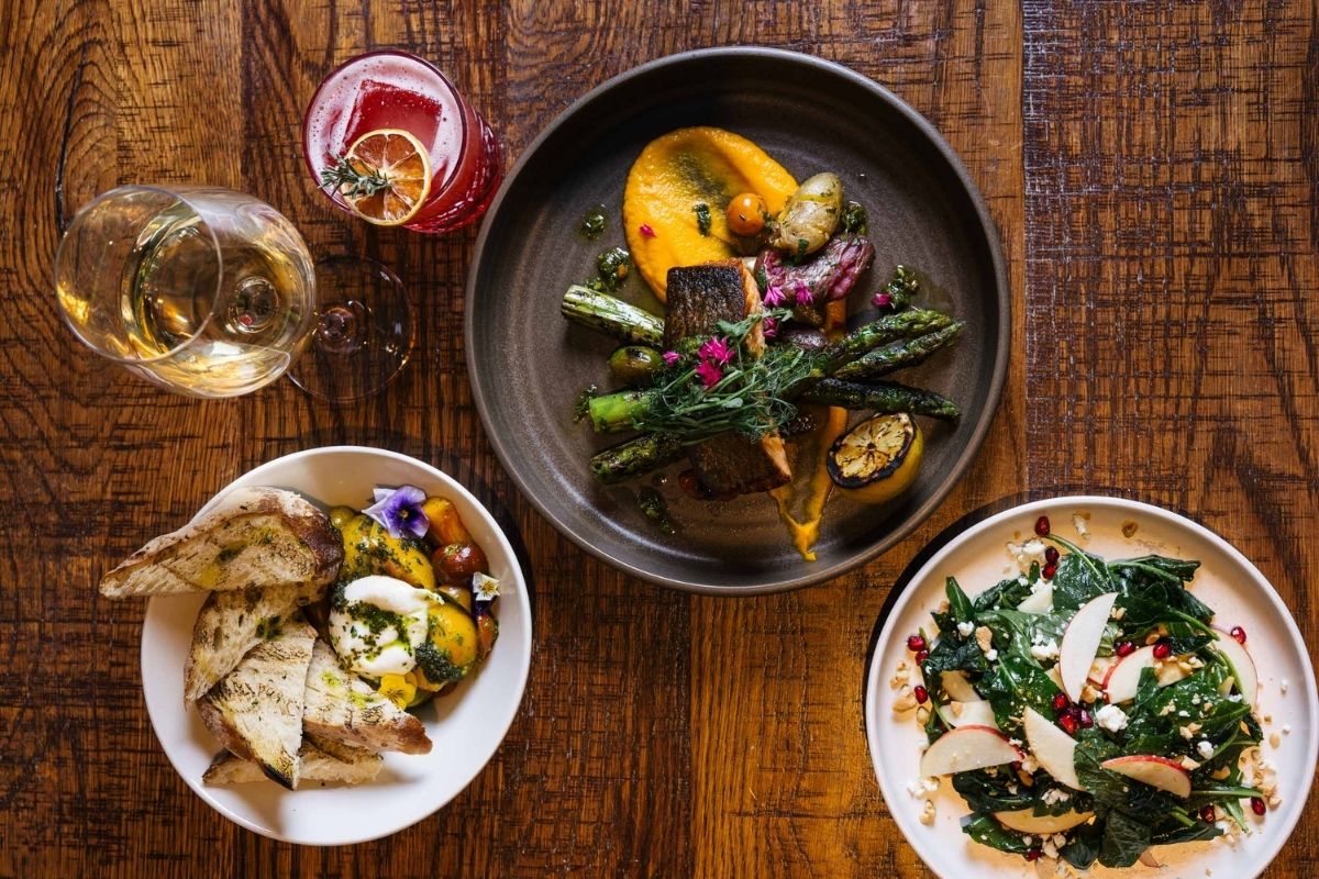 a table with plates of food and drinks