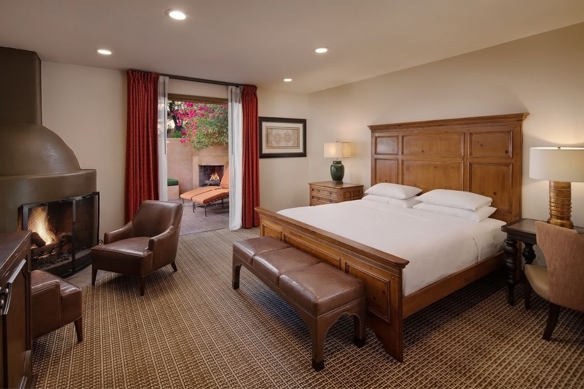 a bedroom with a bed and a fireplace