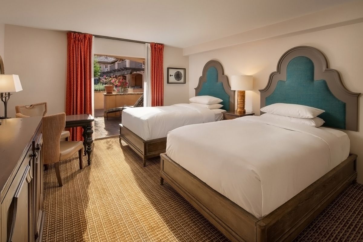 a room with two beds and a table