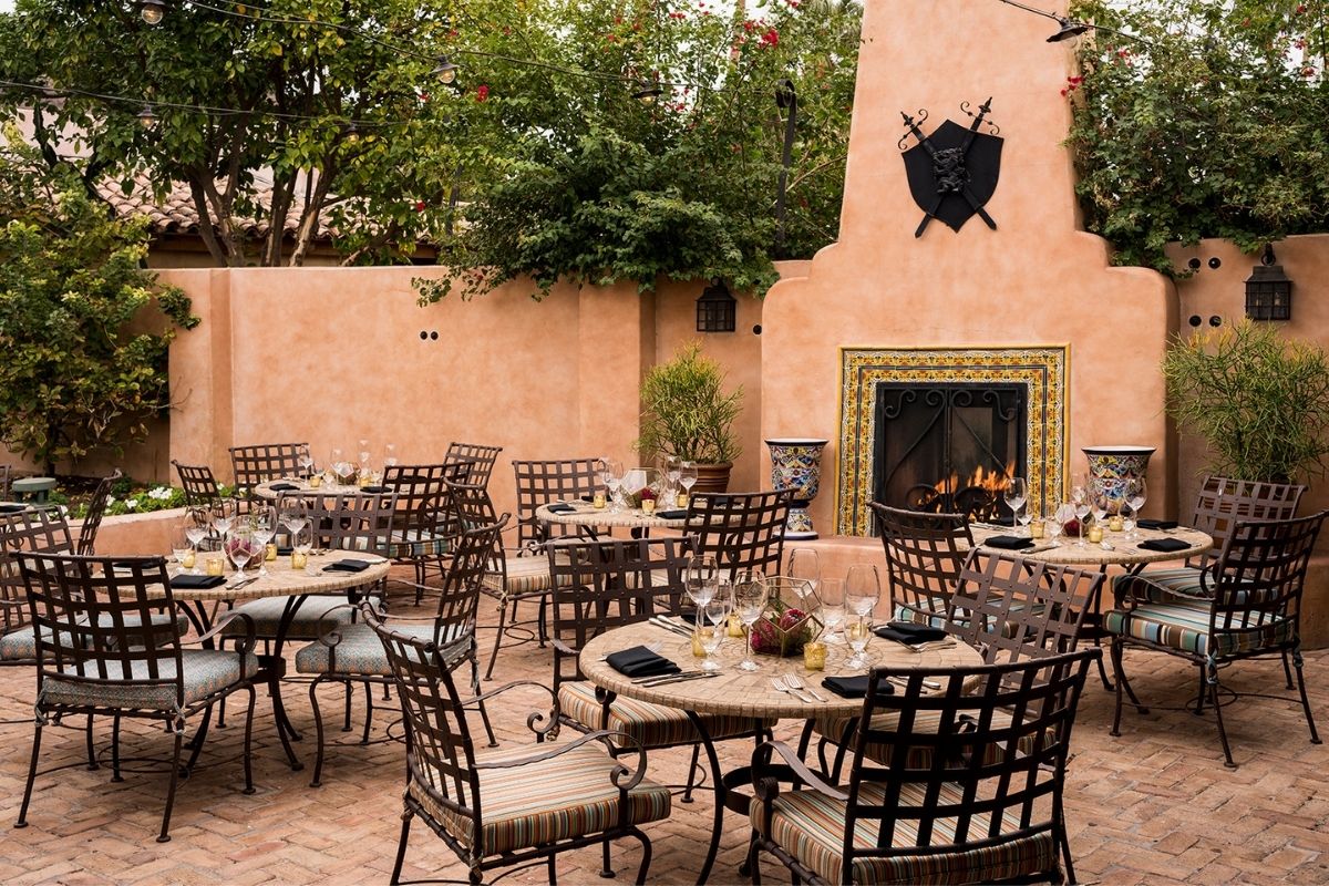 a patio with tables and chairs