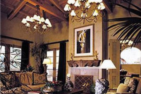 a room with a chandelier and a fireplace