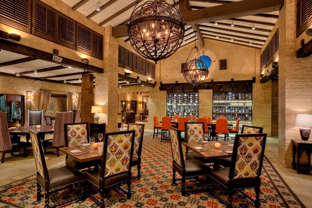 a restaurant with a chandelier and tables