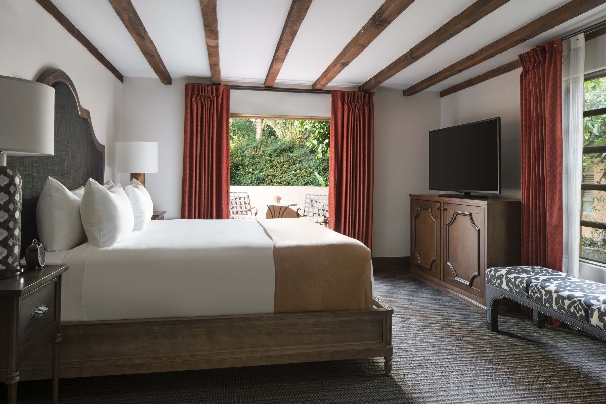 a room with a bed and a television
