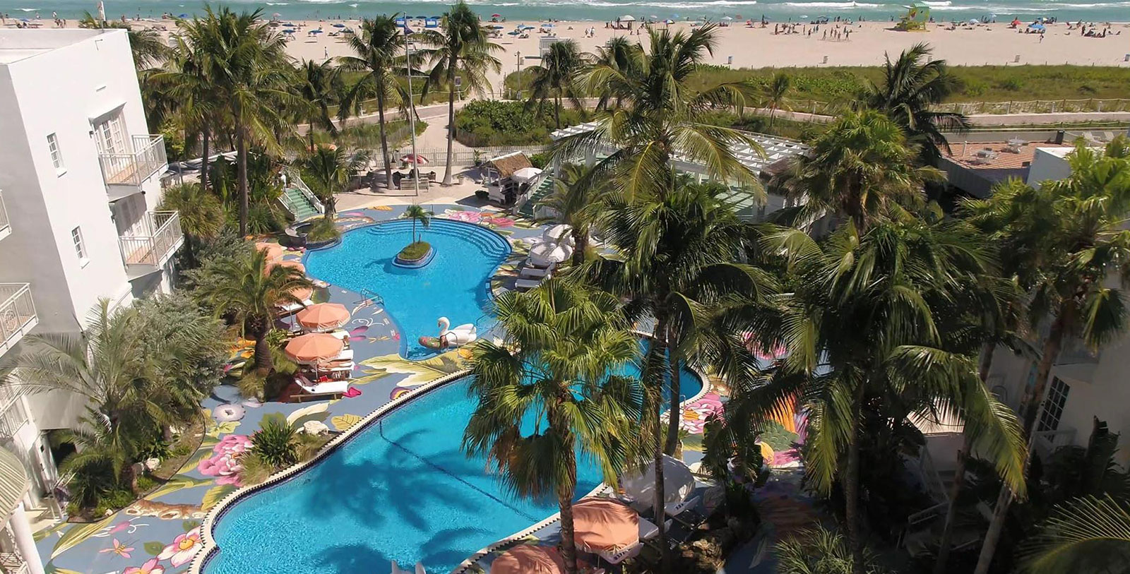 a swimming pool with palm trees and a beach