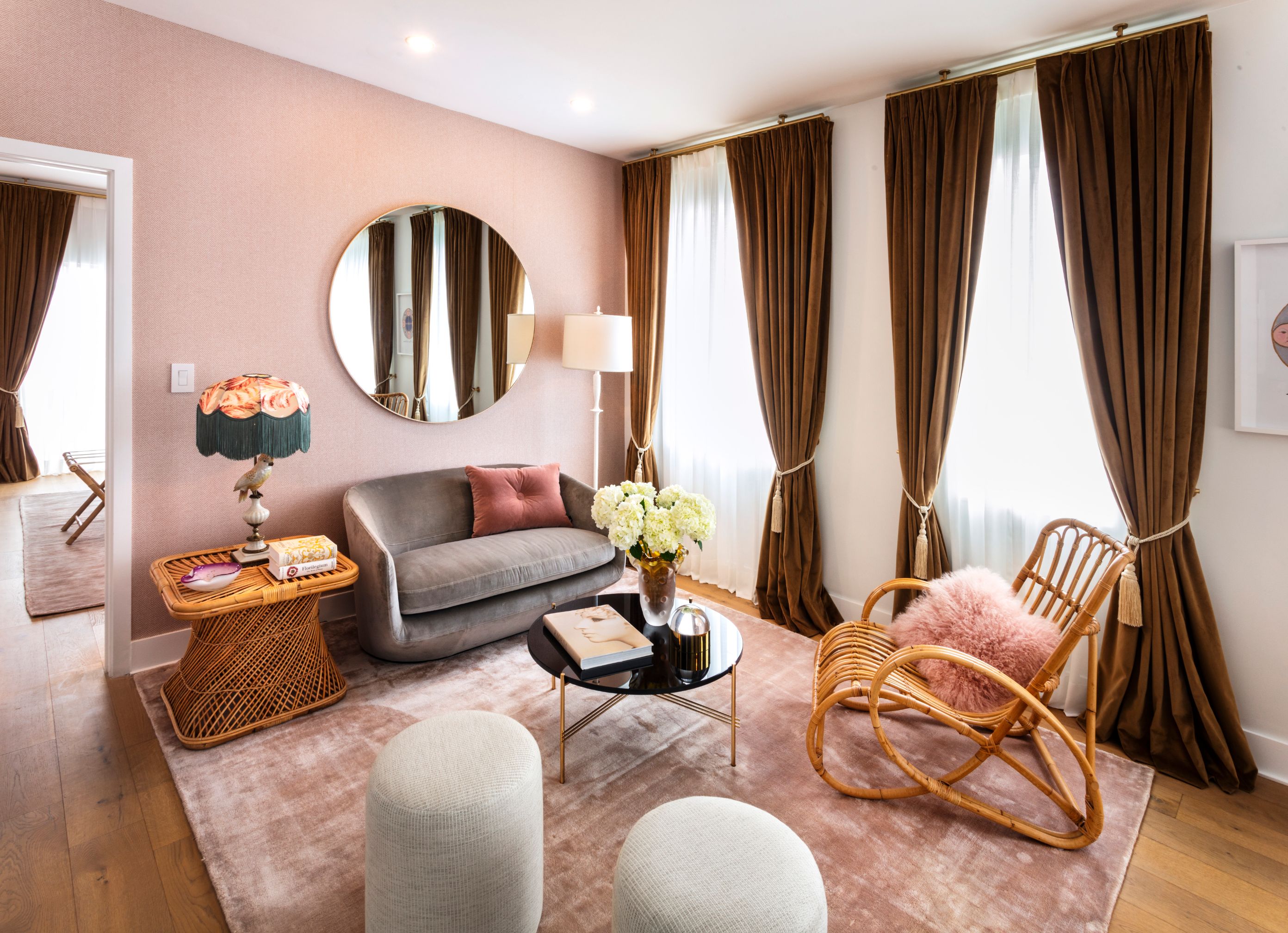 a living room with a round mirror and a couch