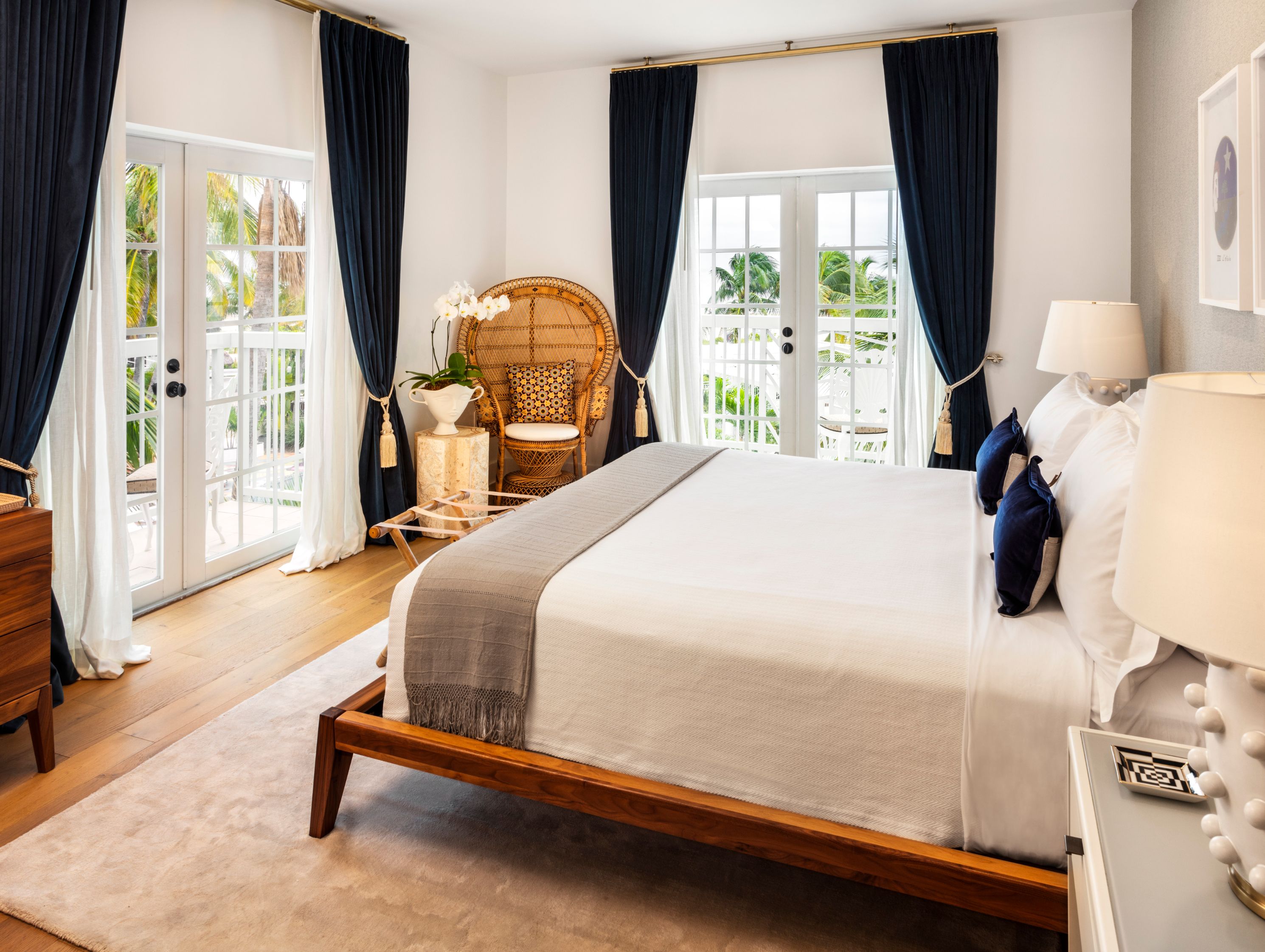 a bedroom with a bed and wicker chair