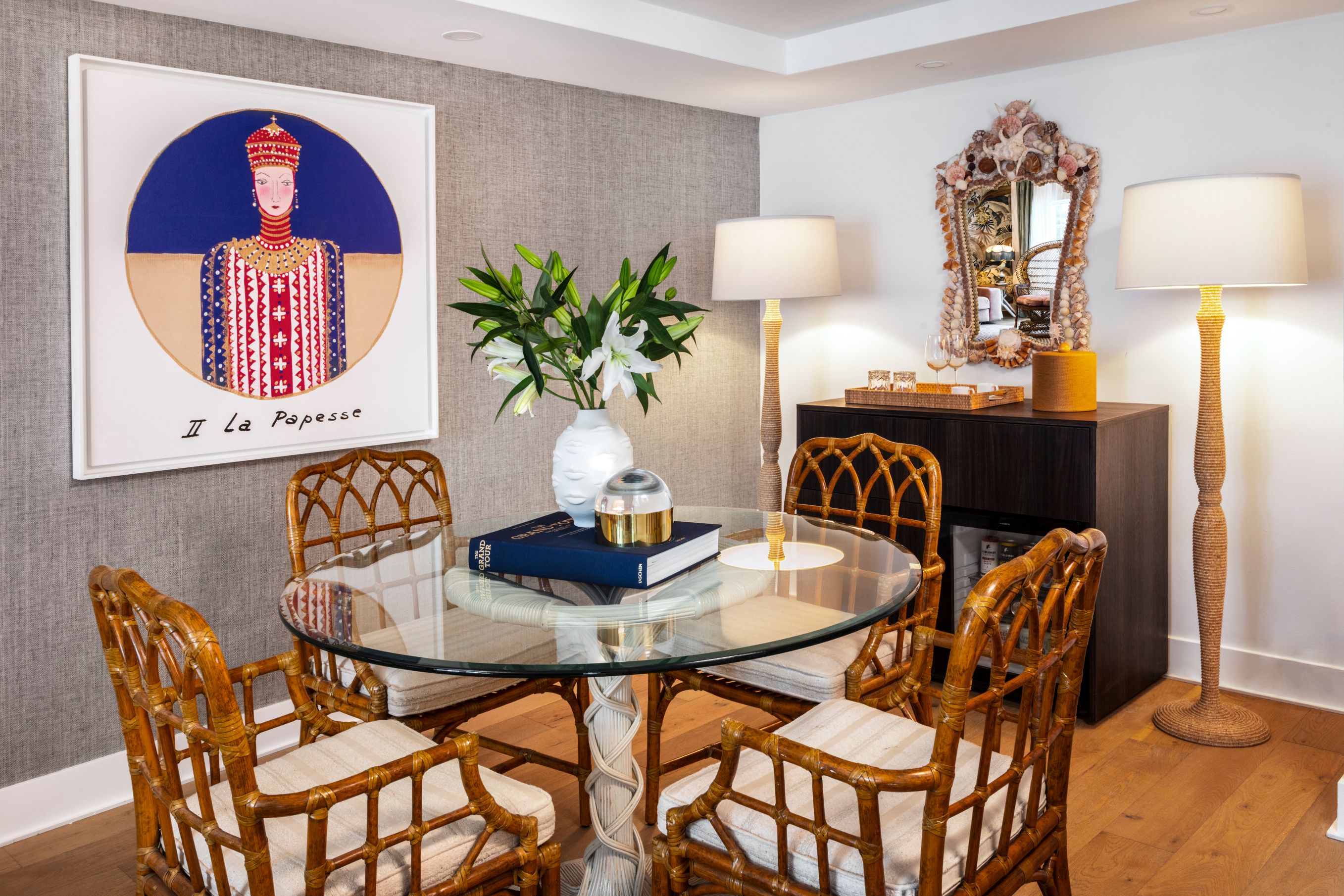a dining room with a glass table and chairs