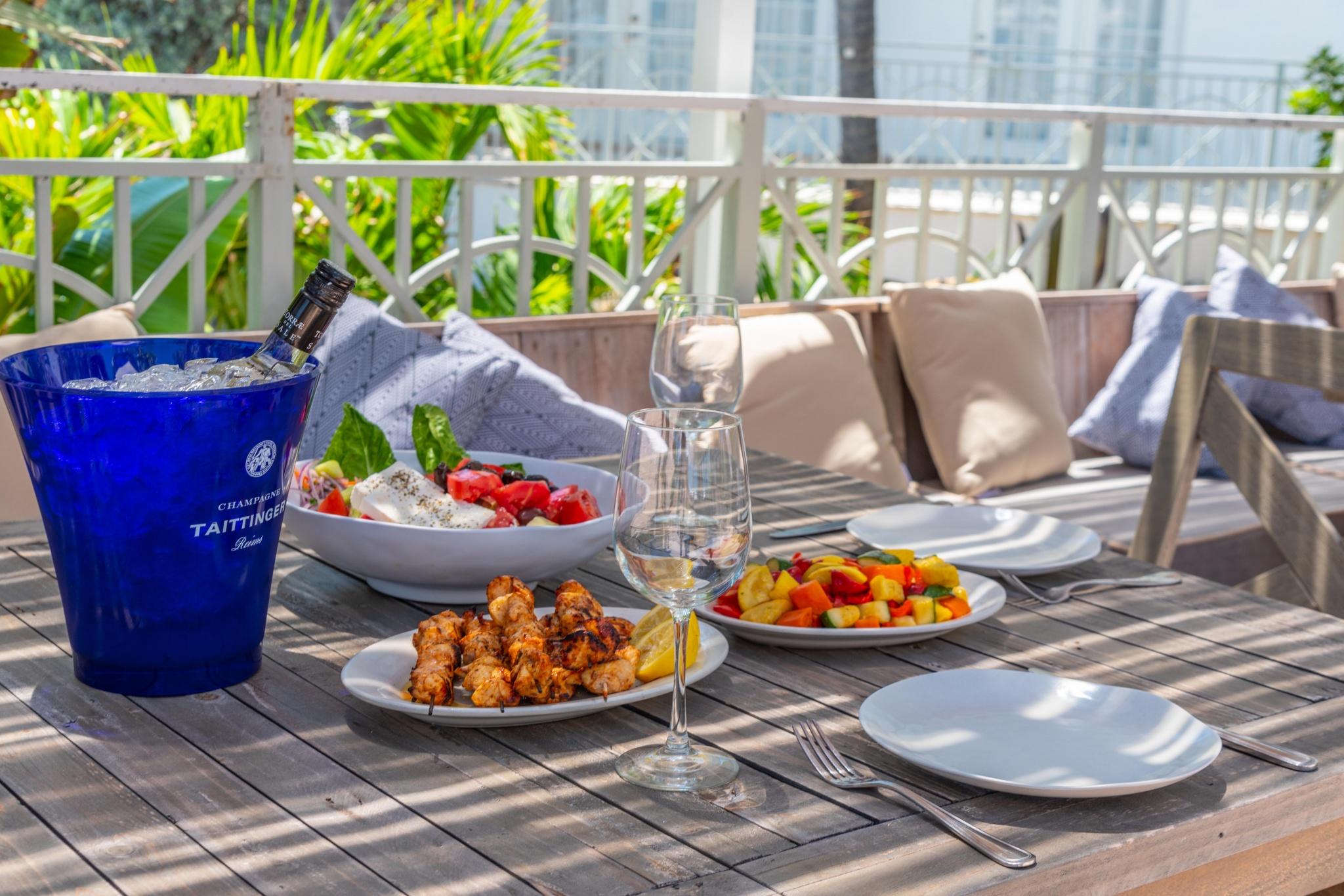 a table with plates of food and wine glasses on it