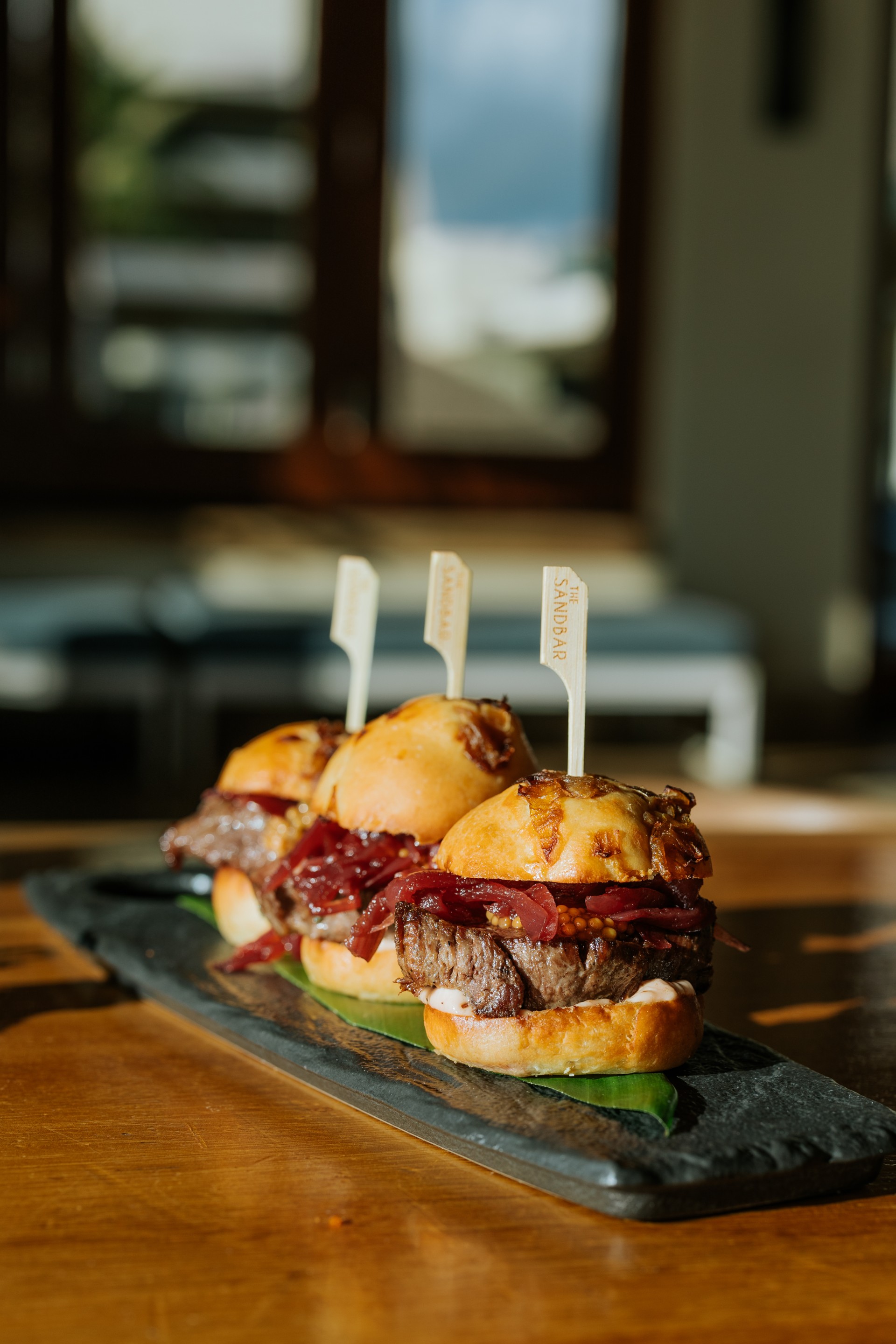 a group of sandwiches on a black plate