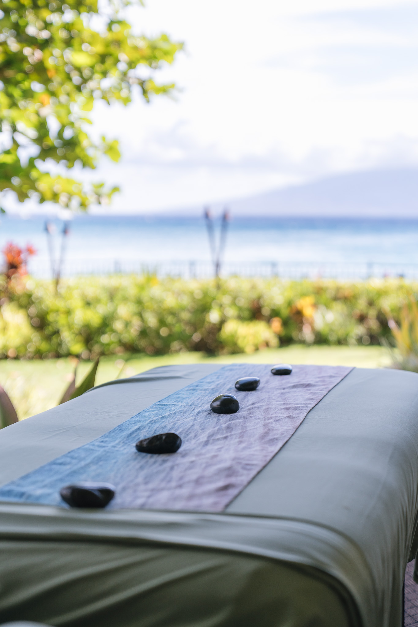 a massage table with rocks on it