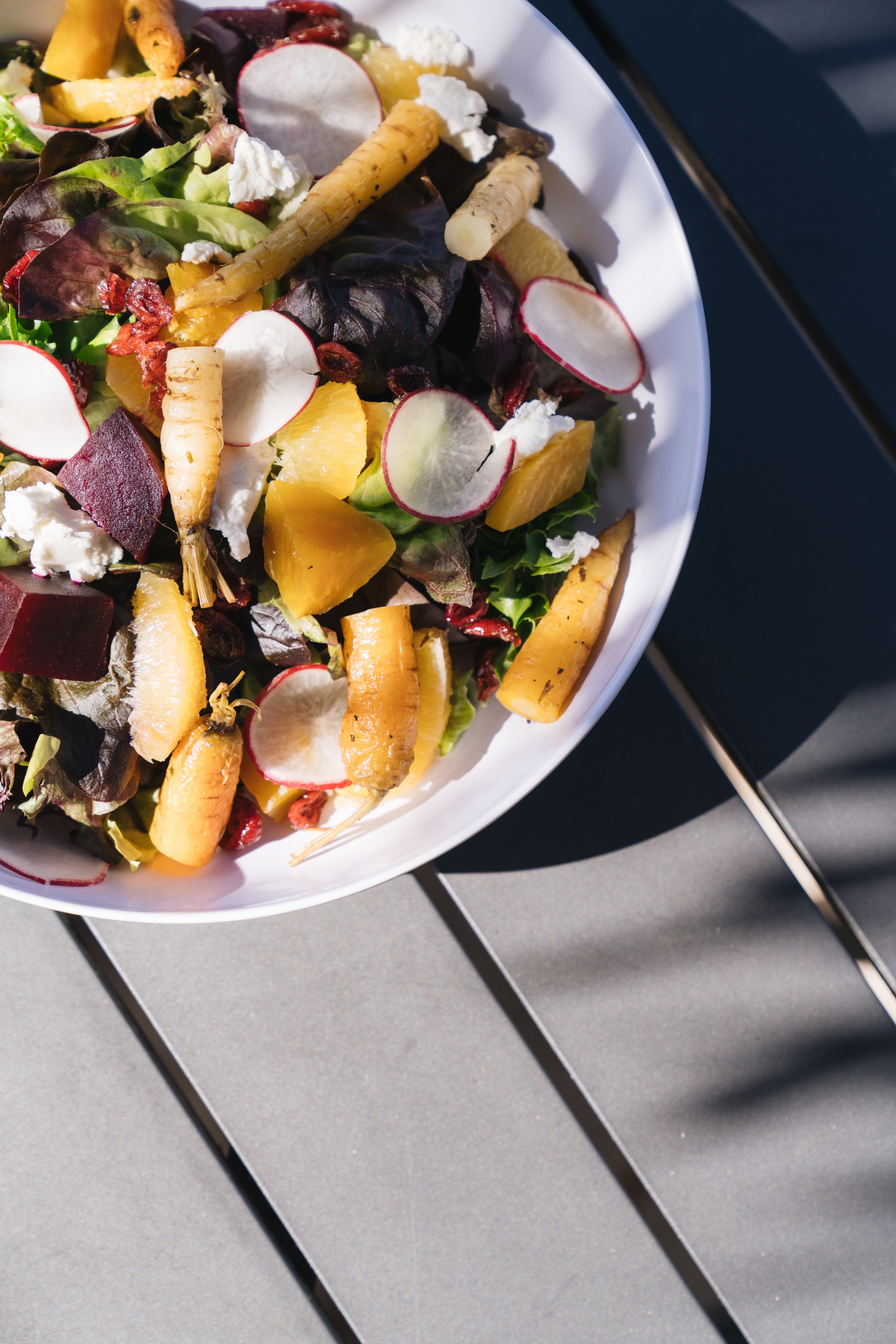 a bowl of salad with vegetables and fruits