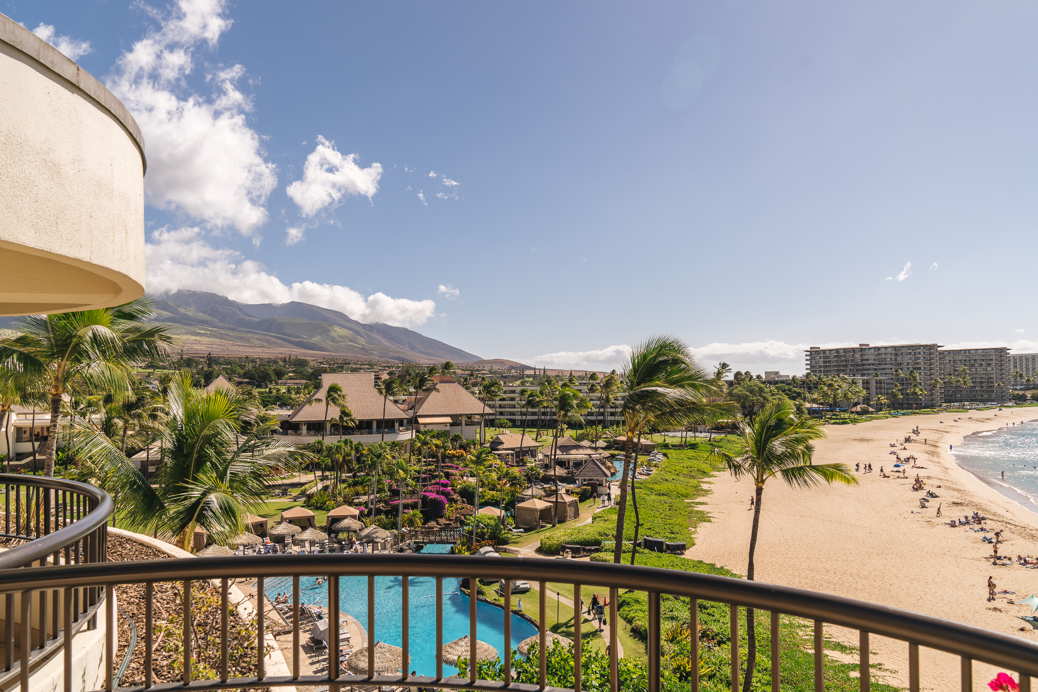 a view of a beach and a pool from a balcony
